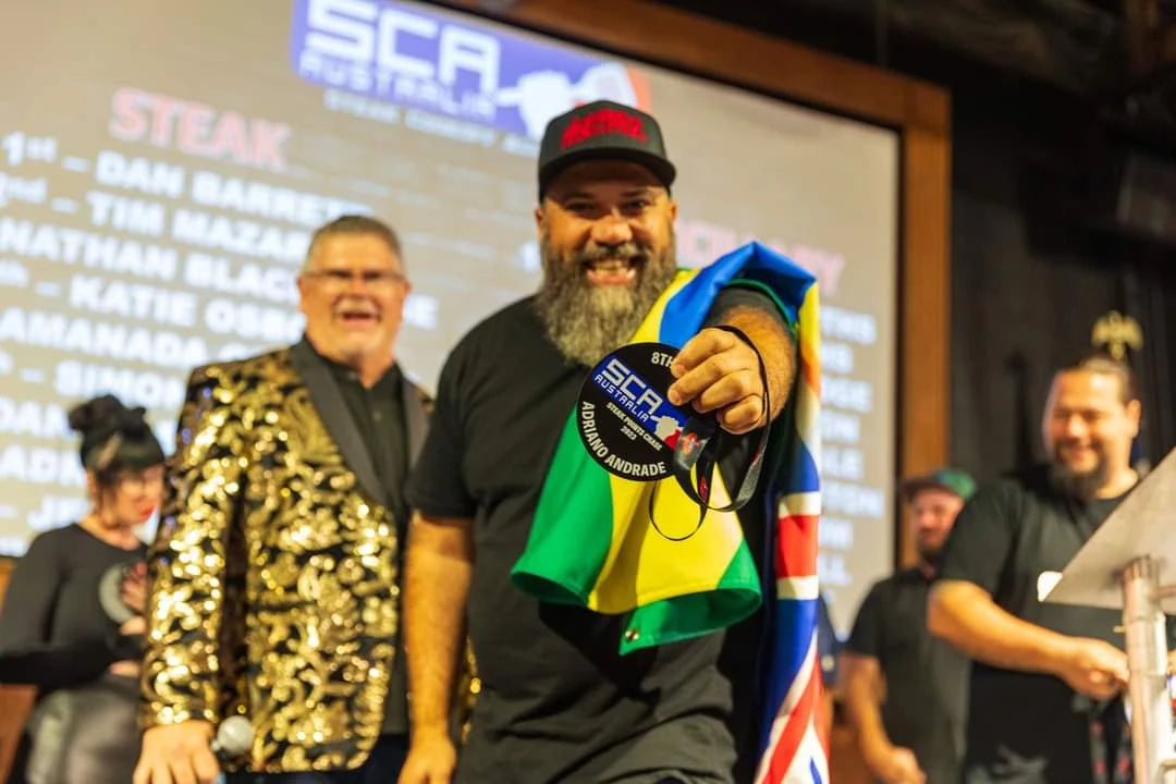 Adriano Andrade showing his SCA Australia medal, with Brazilian and Australian flags