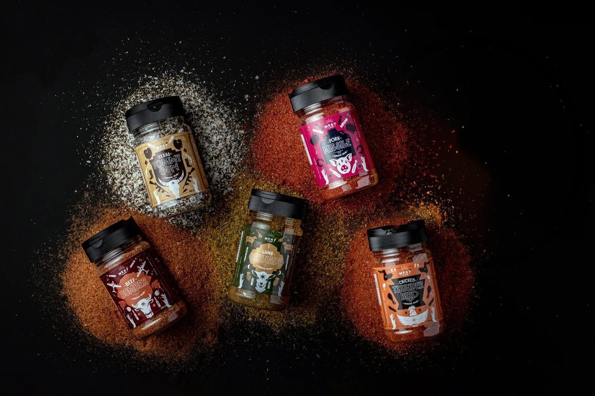 Five Meat Lab rubs photographed with their seasonings on a dark surface