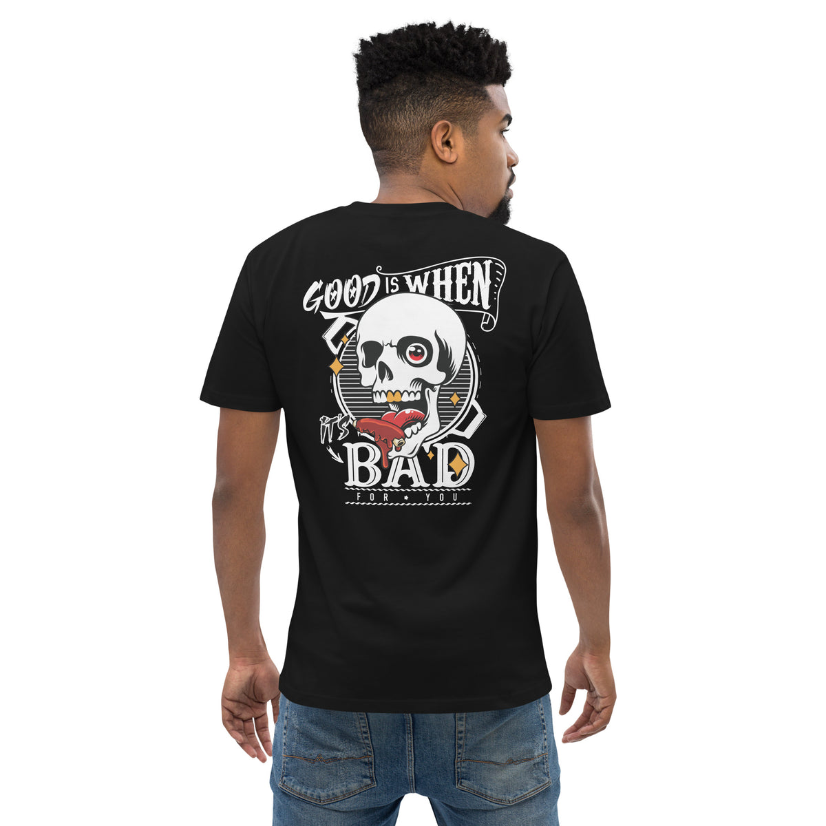 Man wearing the tee seen from behind, the skull print across his back