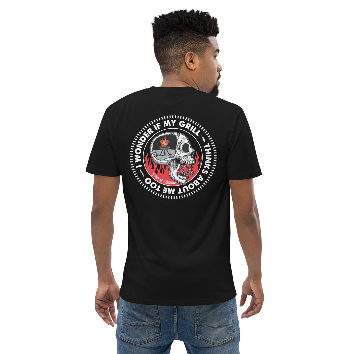 Man wearing the tee seen from behind, the circular skull print across his back