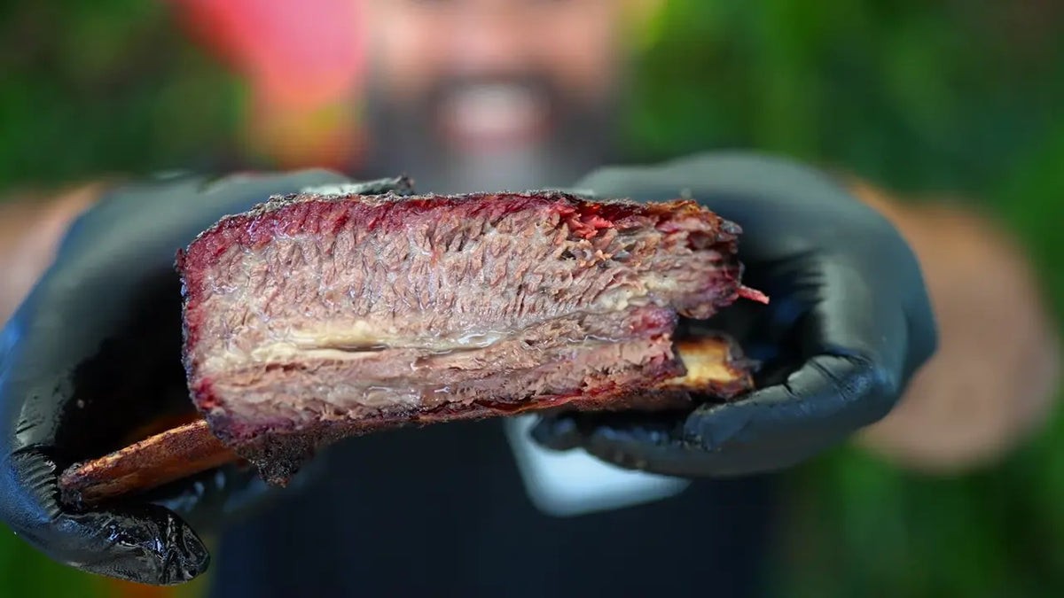 Ready to serve. Smoked beef rib held by Adriano, from his Xtra Mojo recipe video